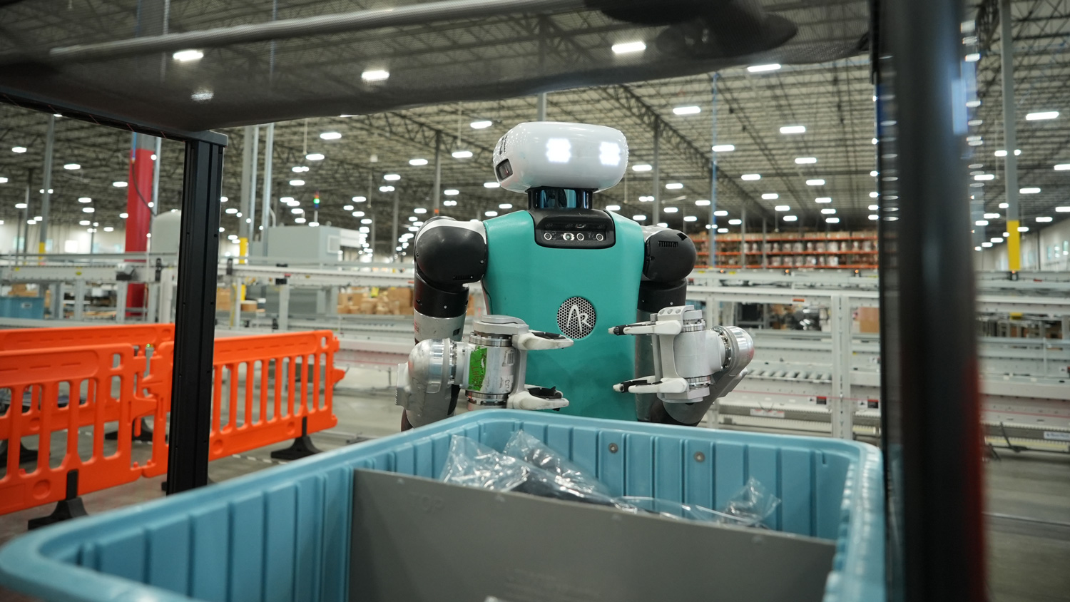 Robô Digit diante de uma caixa azul em um centro de distribuição da GXO.